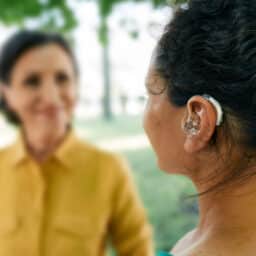 Woman with hearing loss interacts with a friend