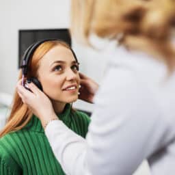 Woman about to start a hearing test.