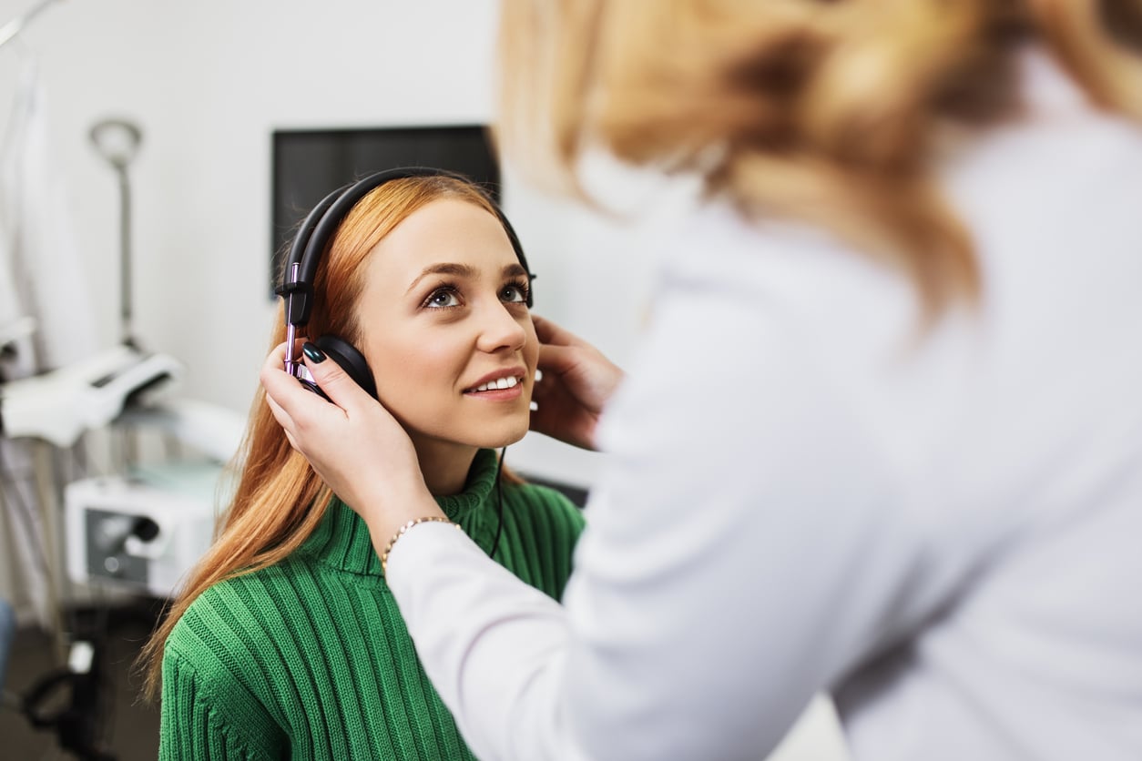Woman about to start a hearing test.
