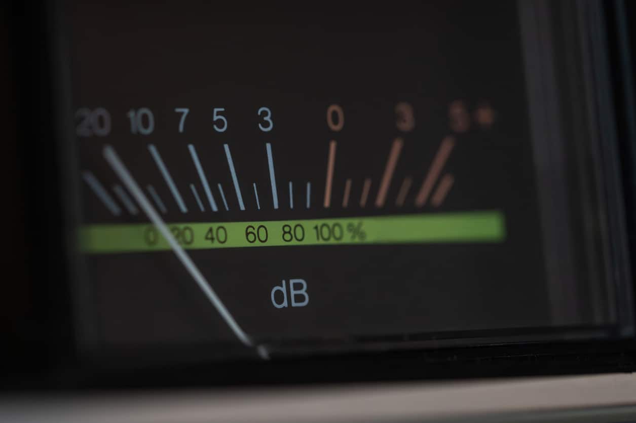 Analog decibel meter of a vintage stereo amplifier with needle indicator.