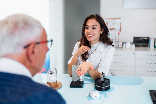 Audiologist talking to her patient about the different hearing aid options.
